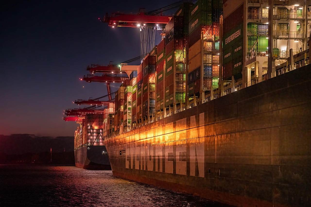 Container ship being loaded at a trade port at night